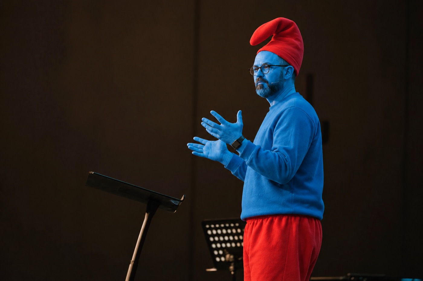 A smurf preaching on stage
