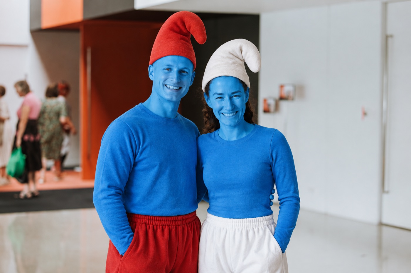 Two smiling smurfs in the church foyer